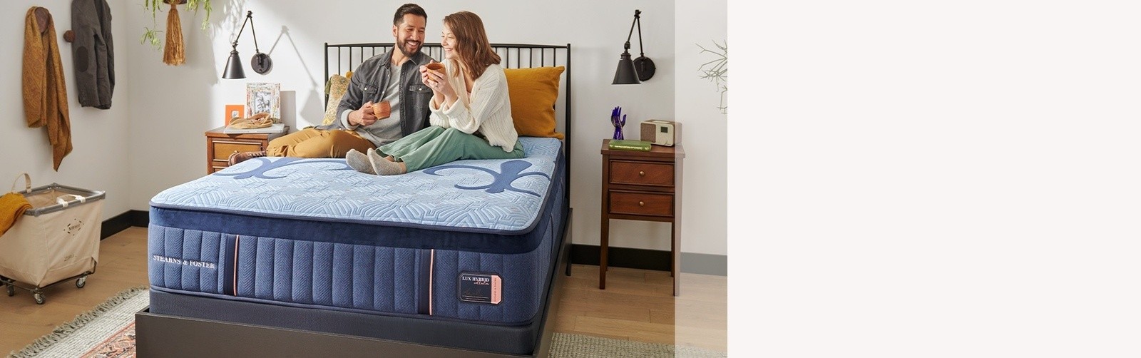 A couple laying on a S&F mattress